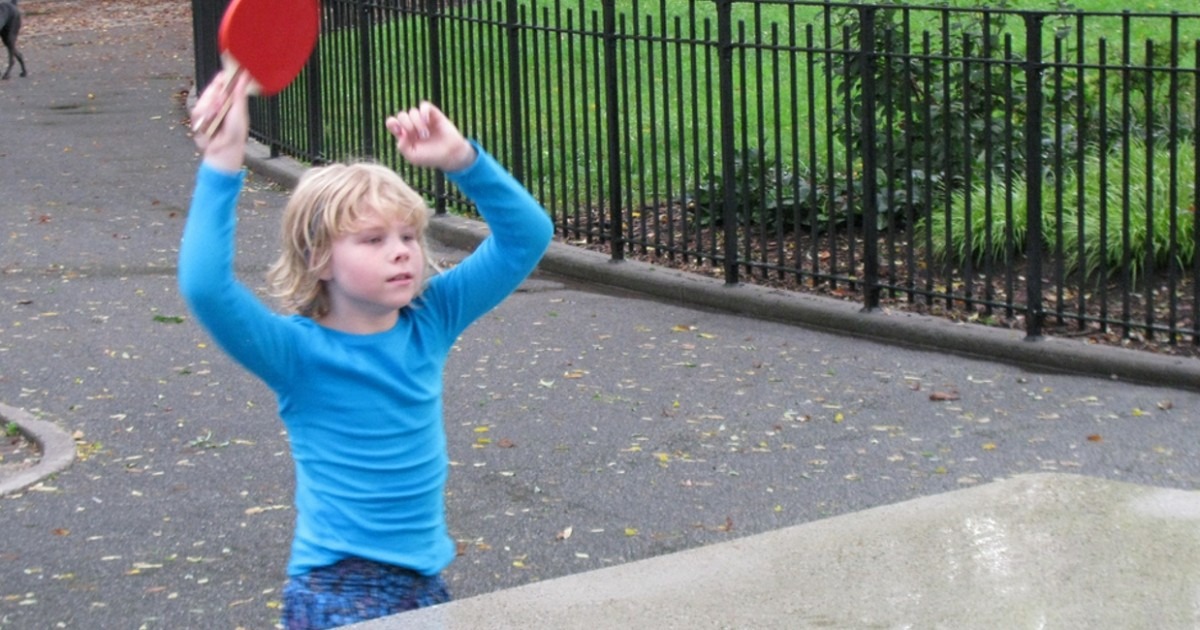 Kids playing ping pong outside